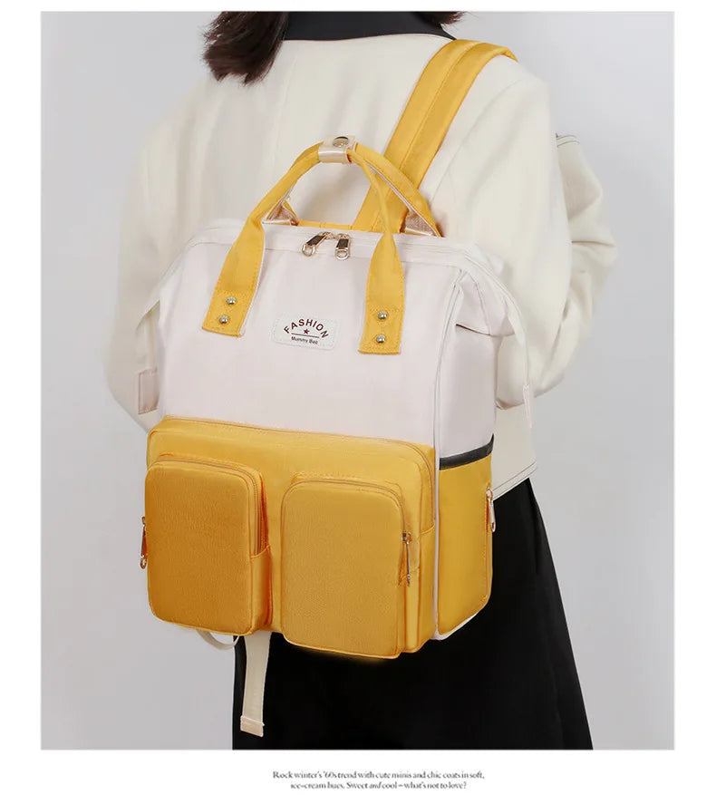 Sac à dos à langer avec anses de portage à la main